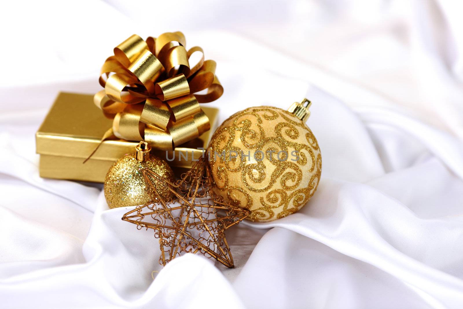  gold christmas ball on white silk