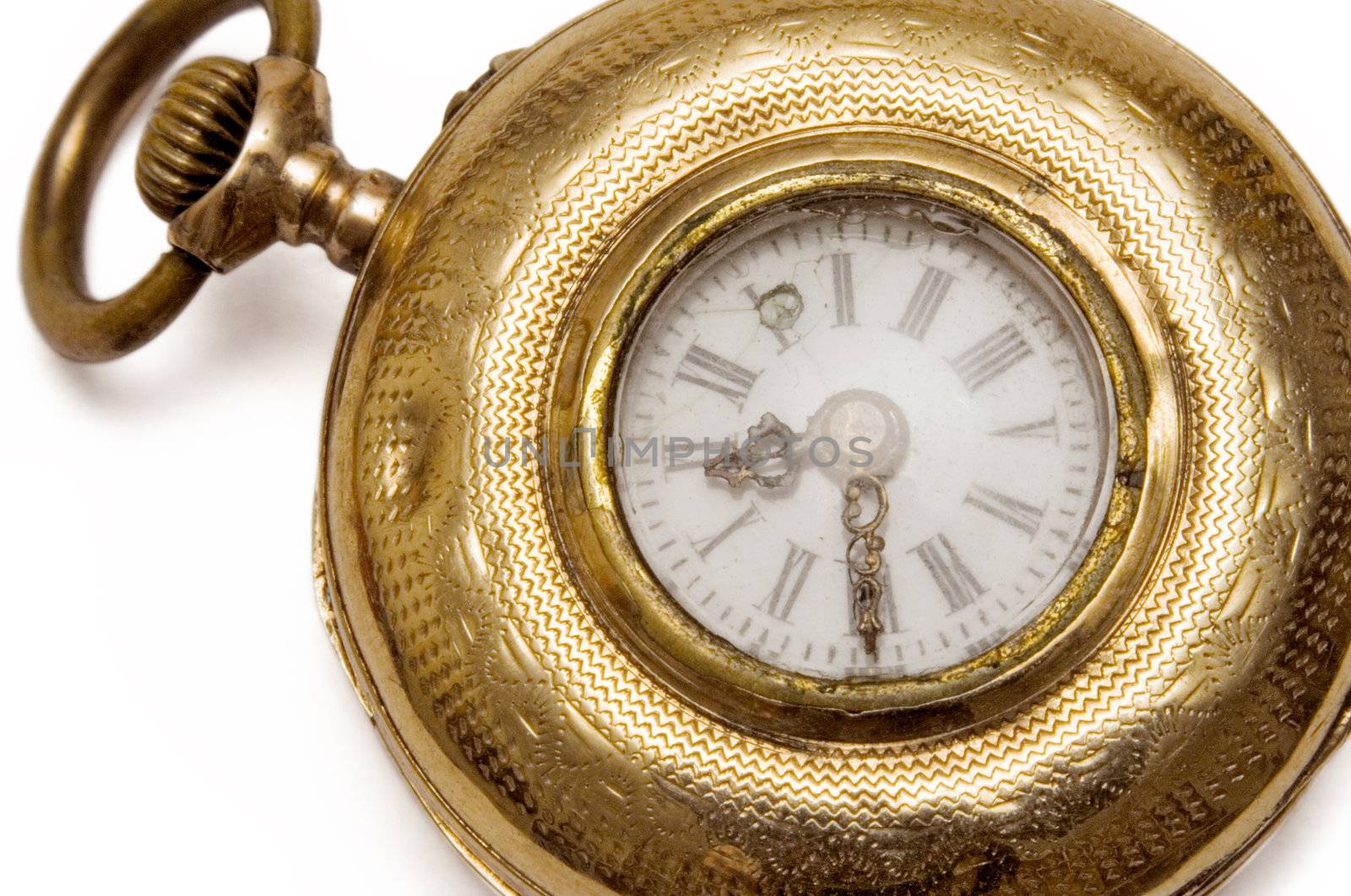 Vintage golden pocket watch isolated on a white background.