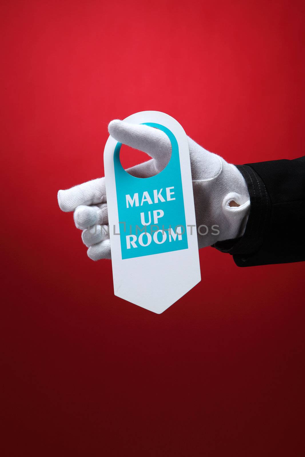  close up of the hotel staff holding a door sign make up room