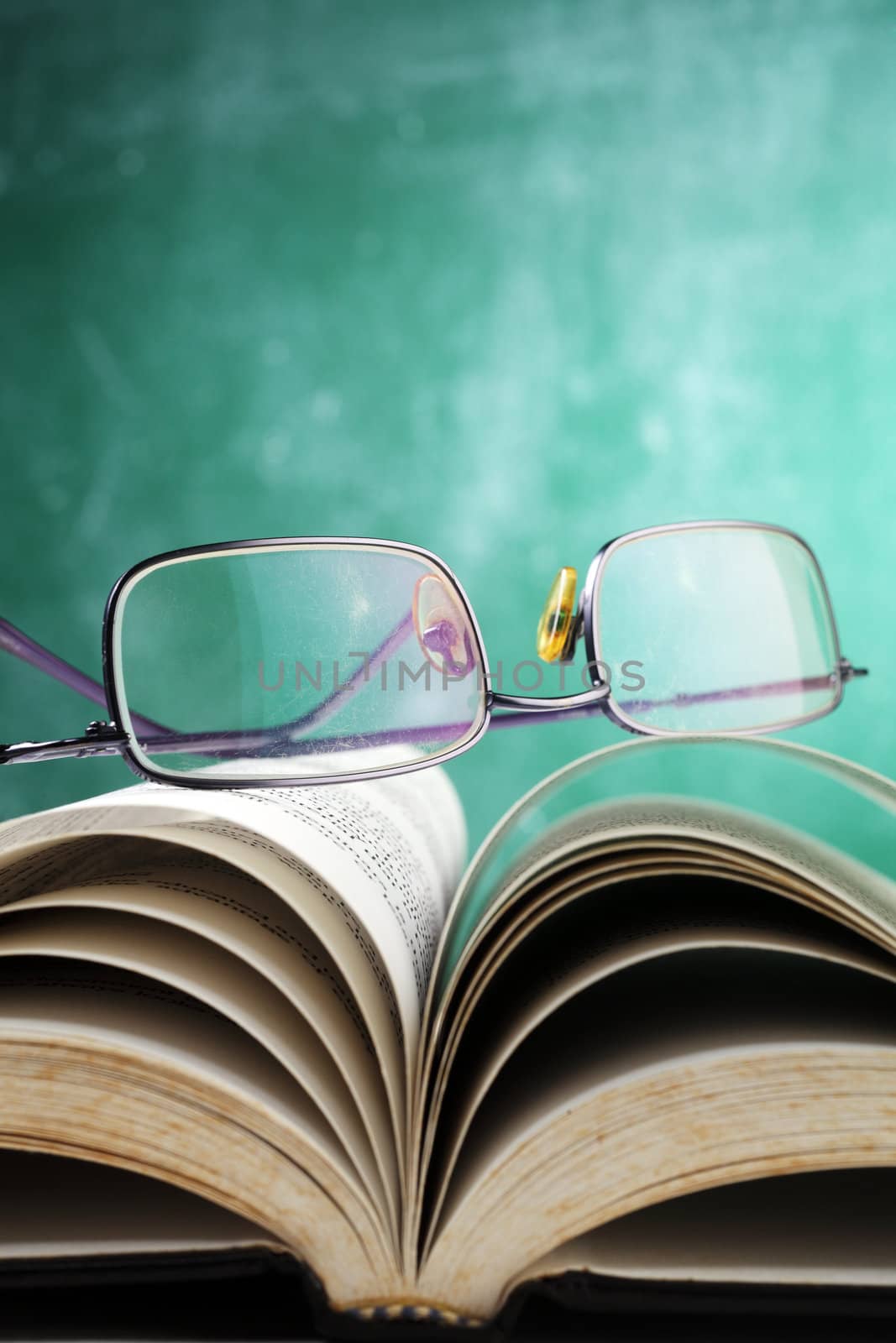 slelective focus on the spectacles on the book