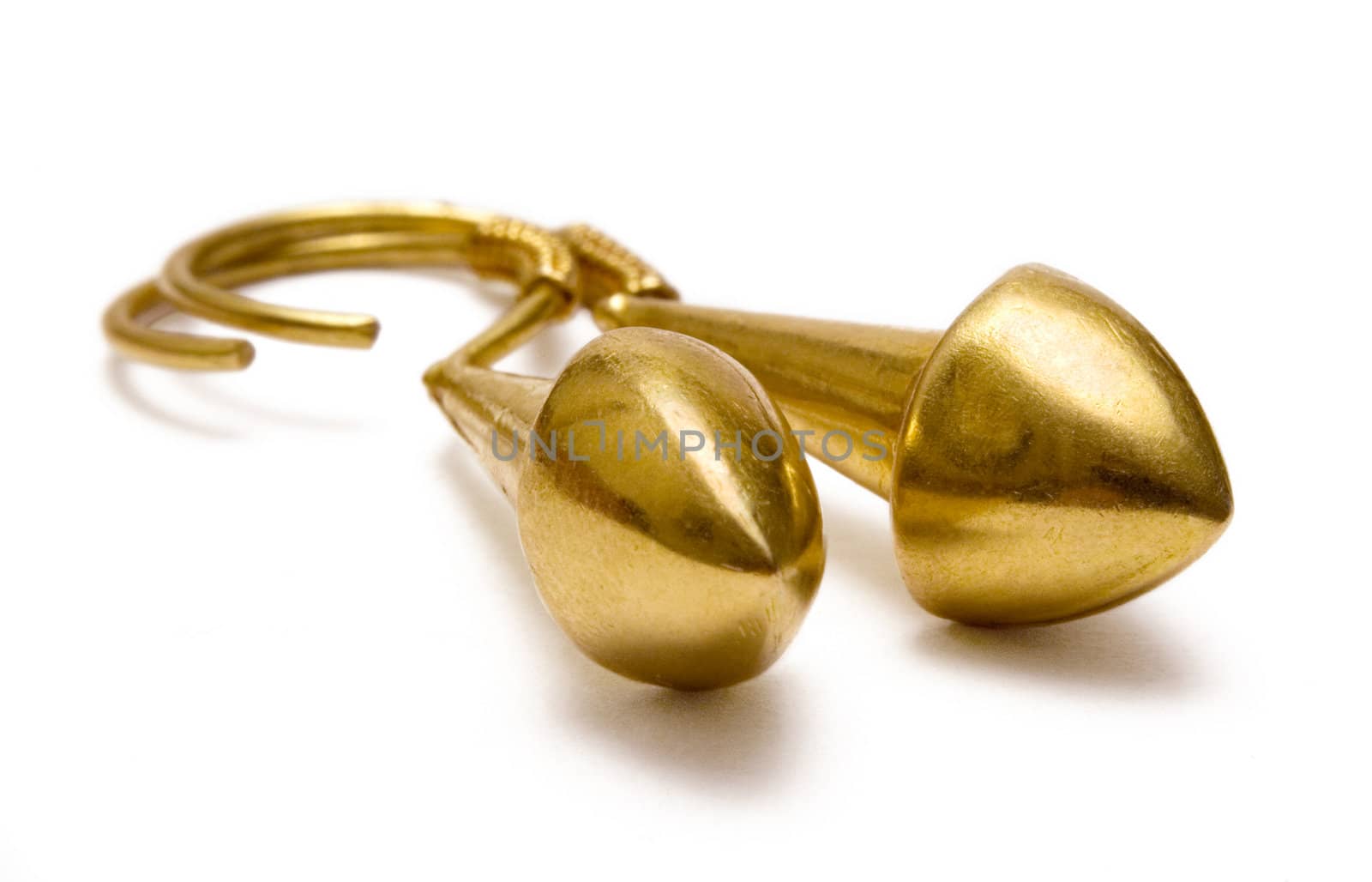 Pair of golden earrings isolated on a white background.