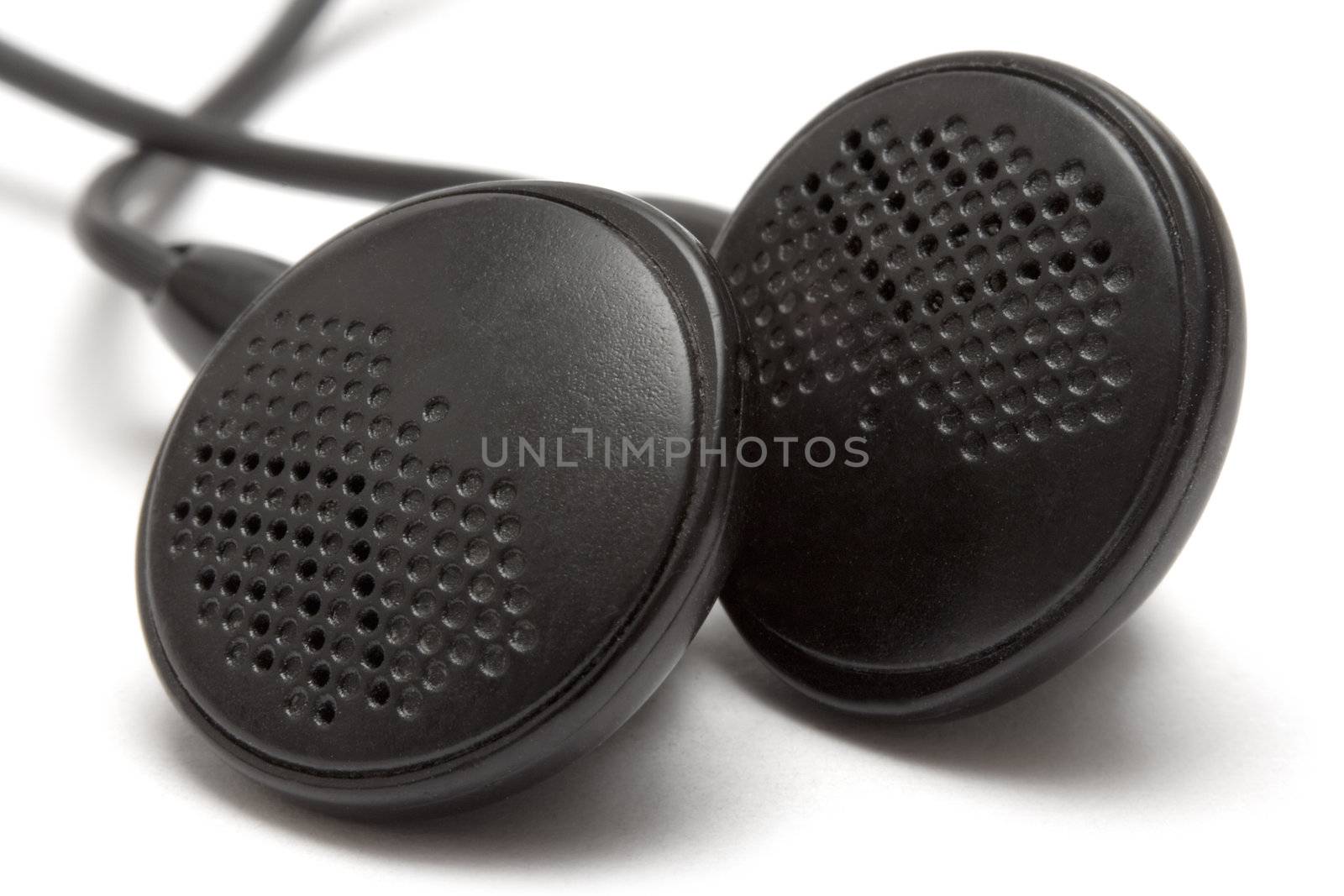 Macro shot of black earbuds. Isolated on a white background.