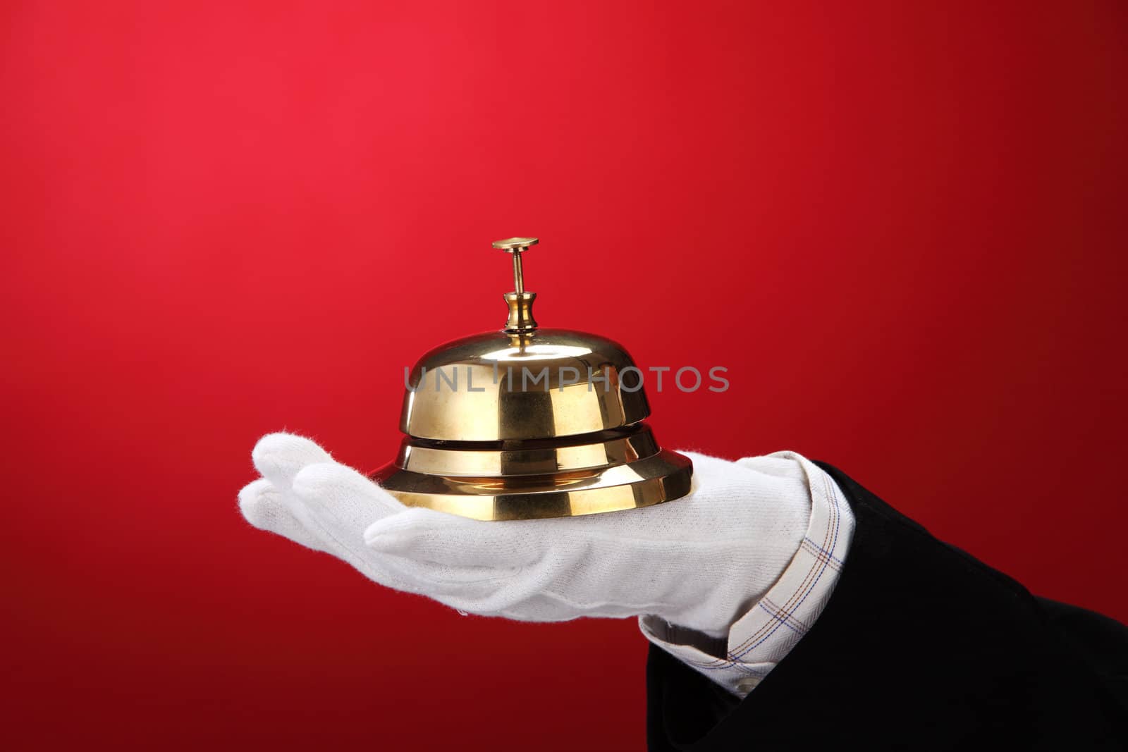 man with hand glove holding a sercive bell