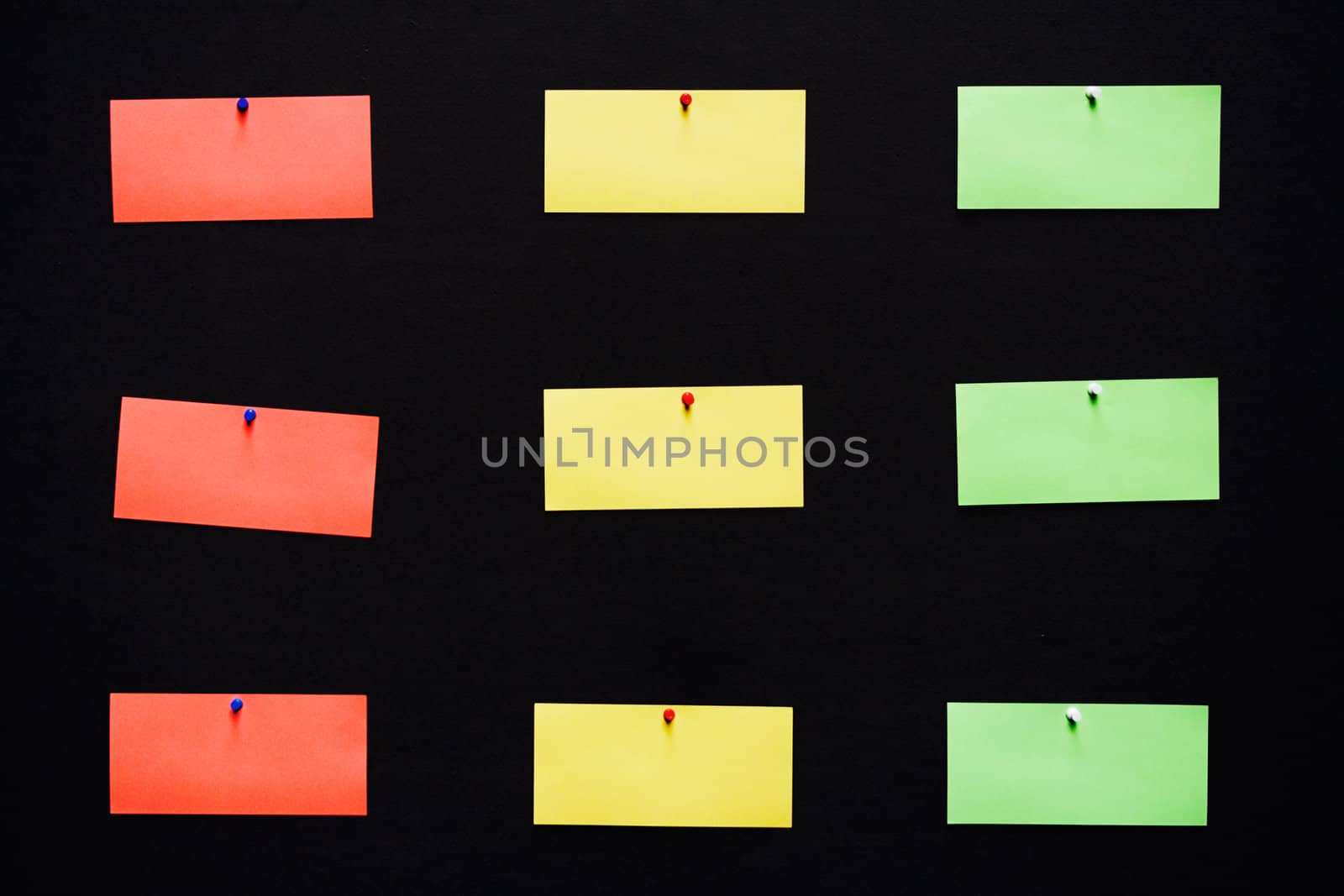 Colorful blank notes pinned to a black background.