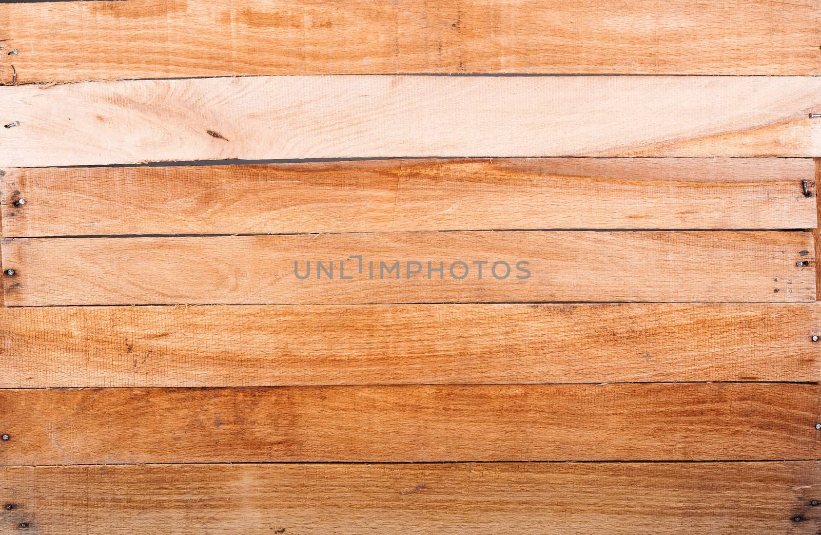 Textured bottom of the wooden box with hammered nails