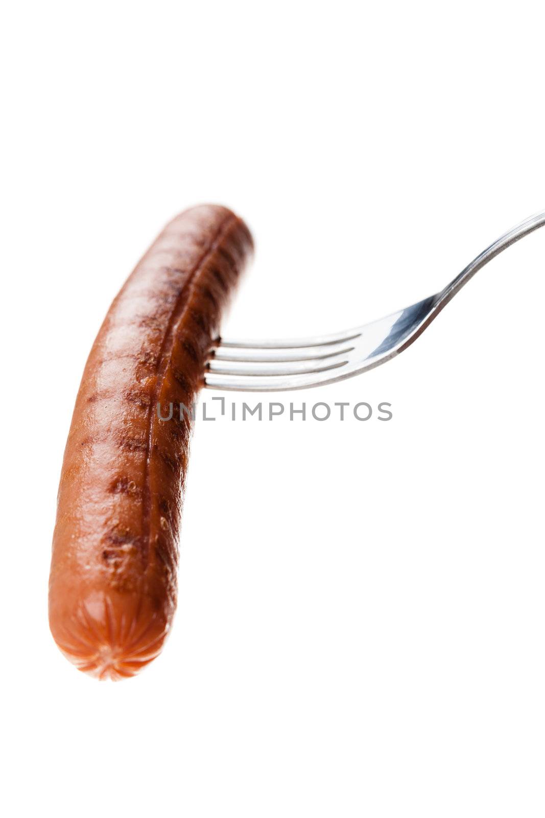 a delicious sausage on a fork over white