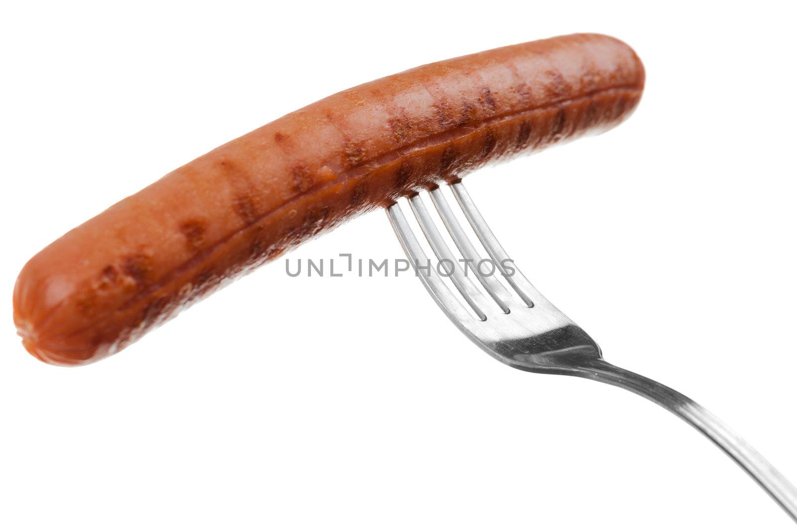 a delicious sausage on a fork over white