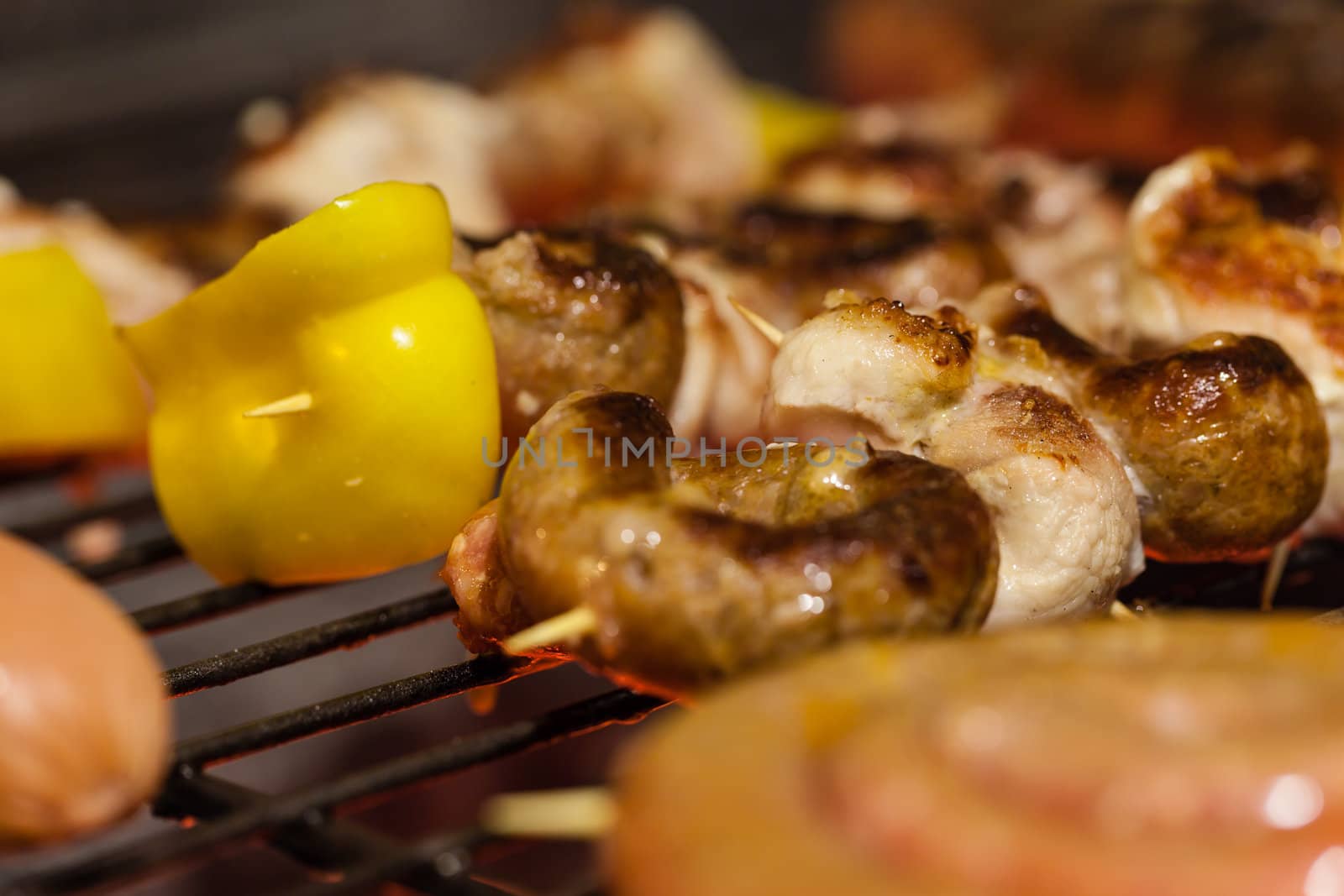 different types of meat cooking outside on a barbecue