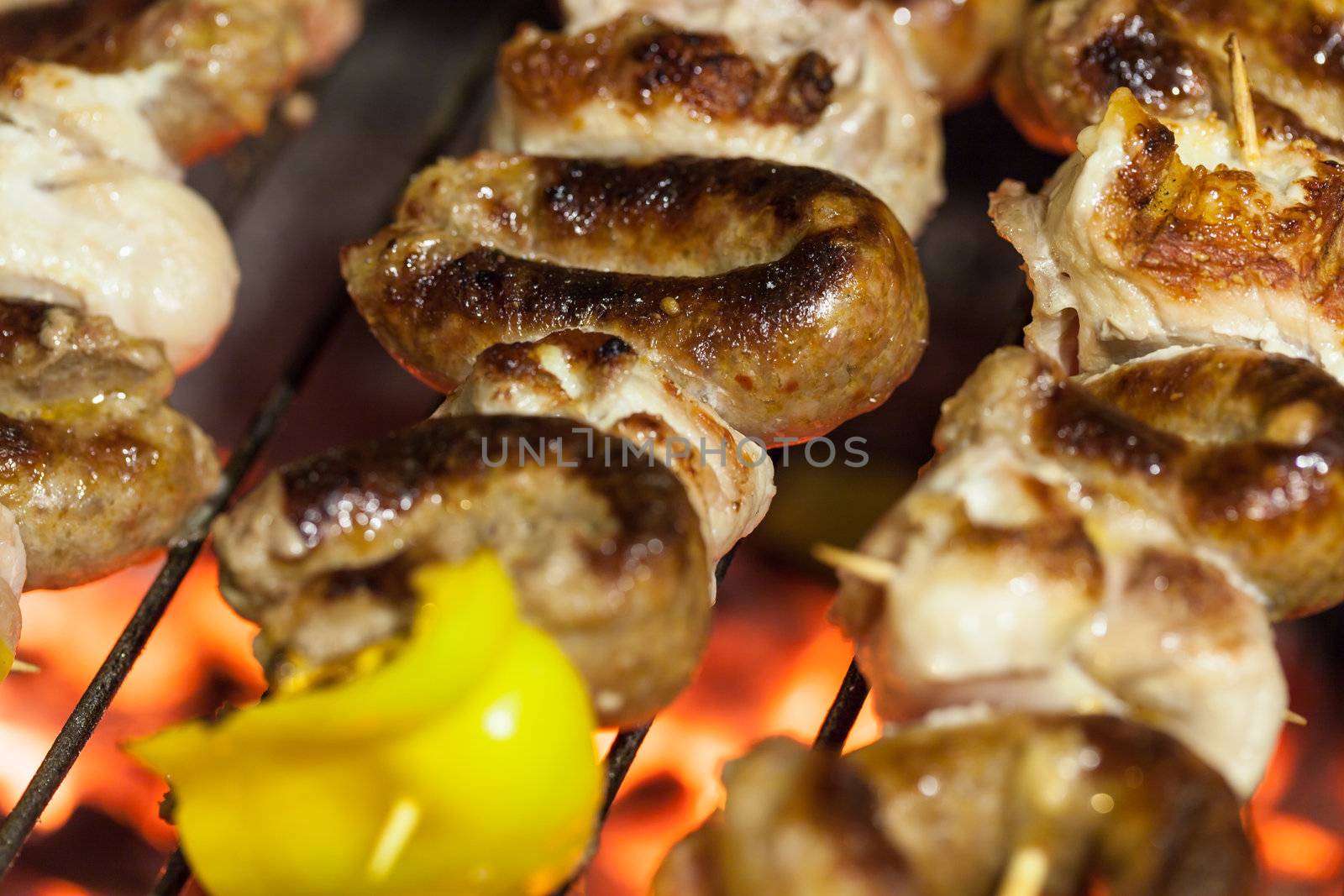 different types of meat cooking outside on a barbecue