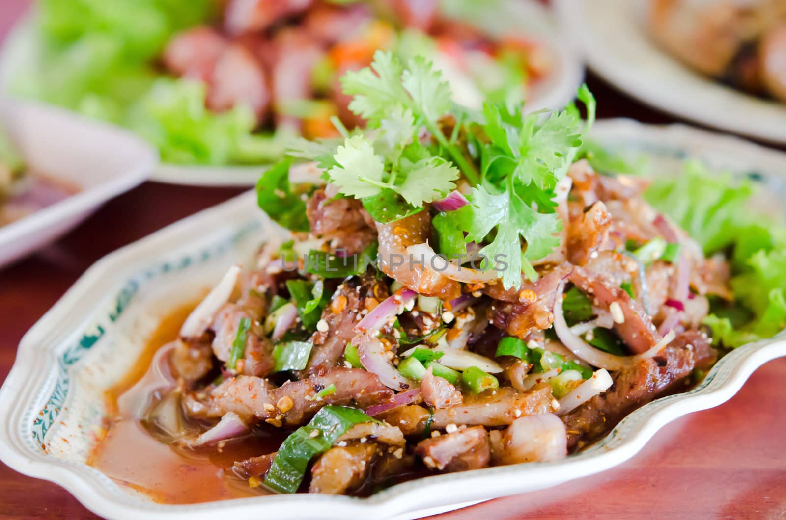 spicy slices pork on dish ,  mix vegetable  and chili sauce