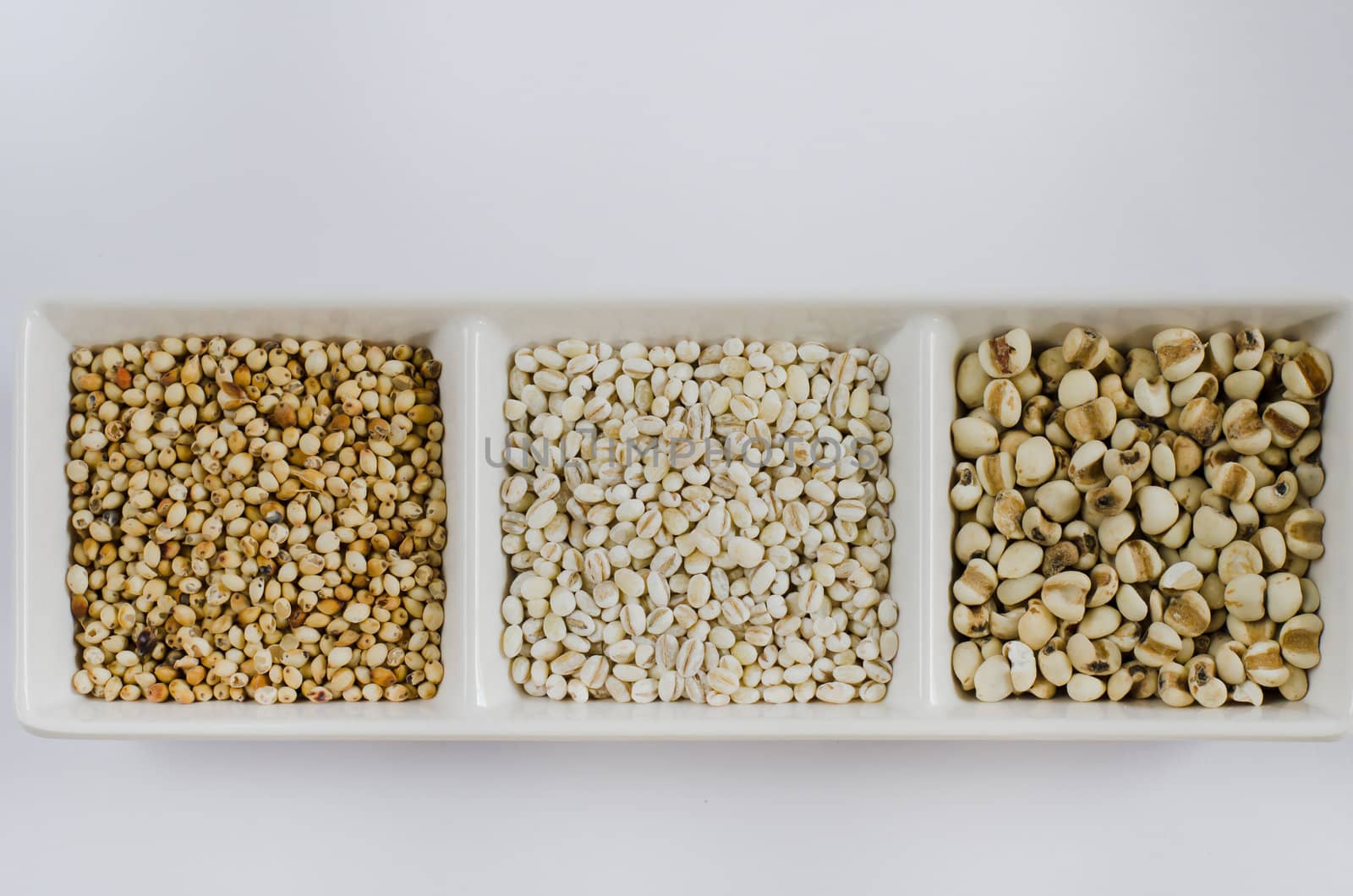 job's tears , barley and millet grains on white bowl