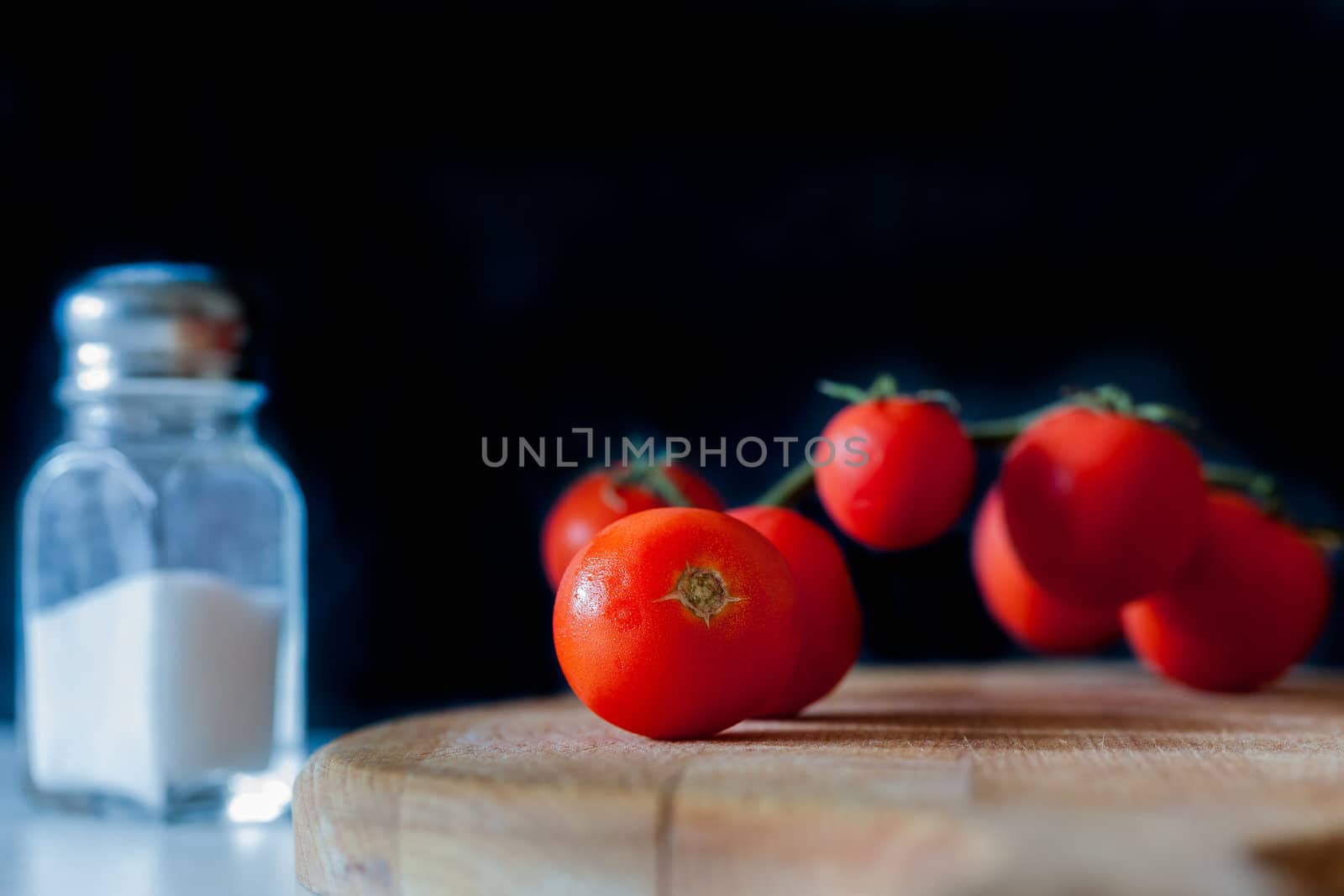 Little tomatoes on a wooden chopping board