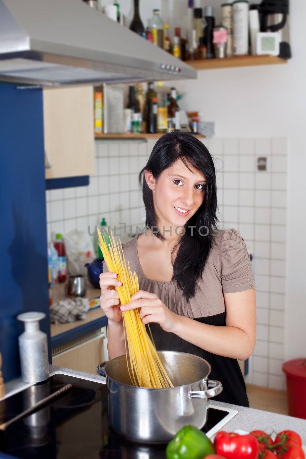 gorgeous young woman cooking spaghetti by bernjuer