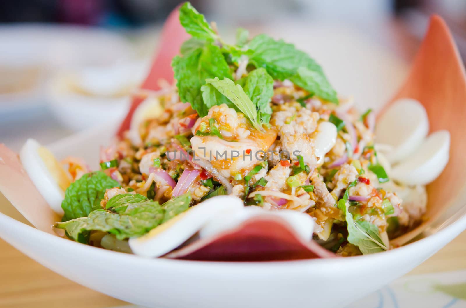 spicy shrimp on a salad with eggs and minced pork