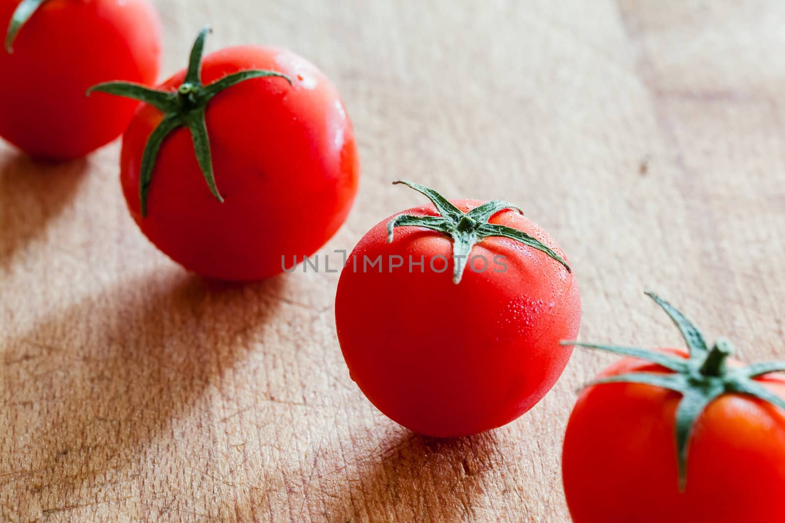 Little tomatoes on a wooden chopping board