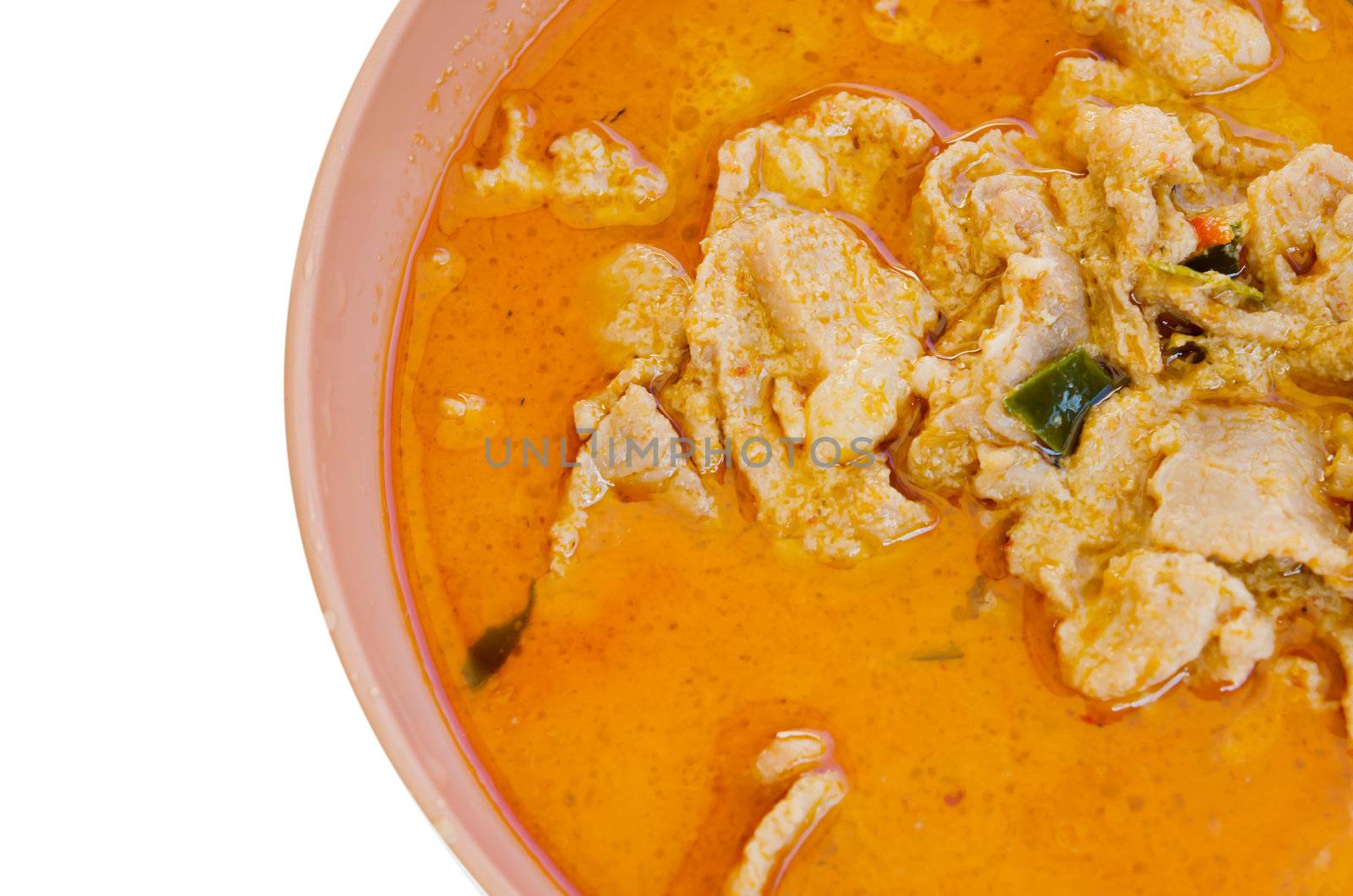  top view pork in ground peanut-coconut cream curry  in pink bowl on white