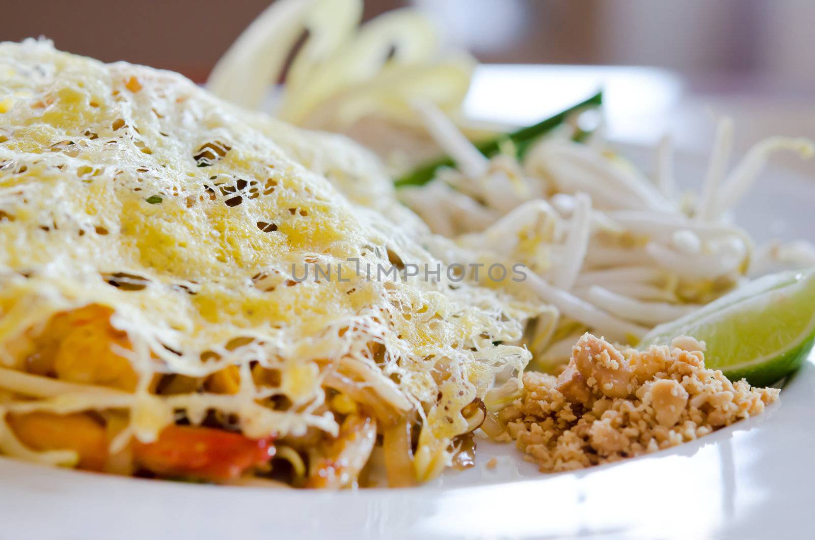 Stir fry noodles and fried egg on top , asian food