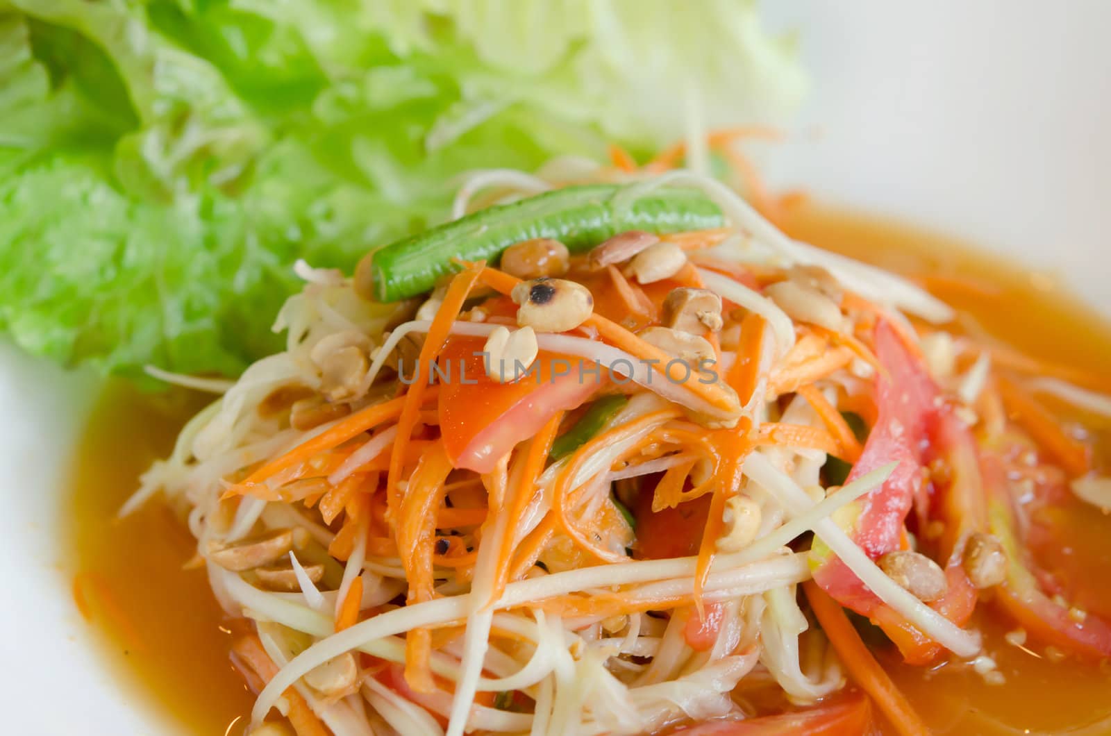 close up thai papaya salad and fresh lettuce