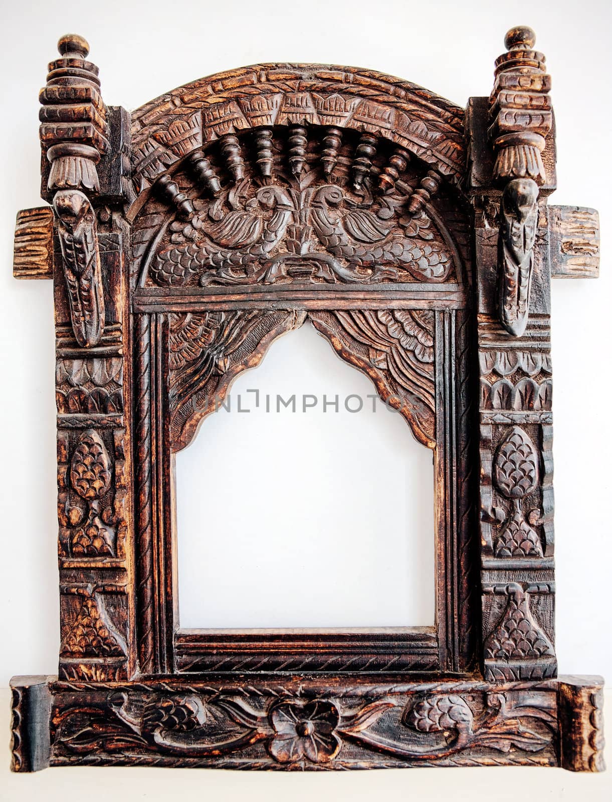 Old carved wooden frame. India. Background.