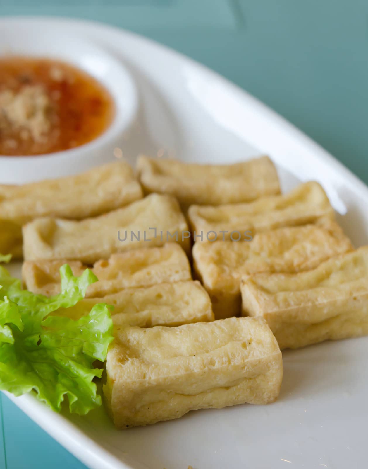 deep fried tofu and fresh vegetable  on white plate