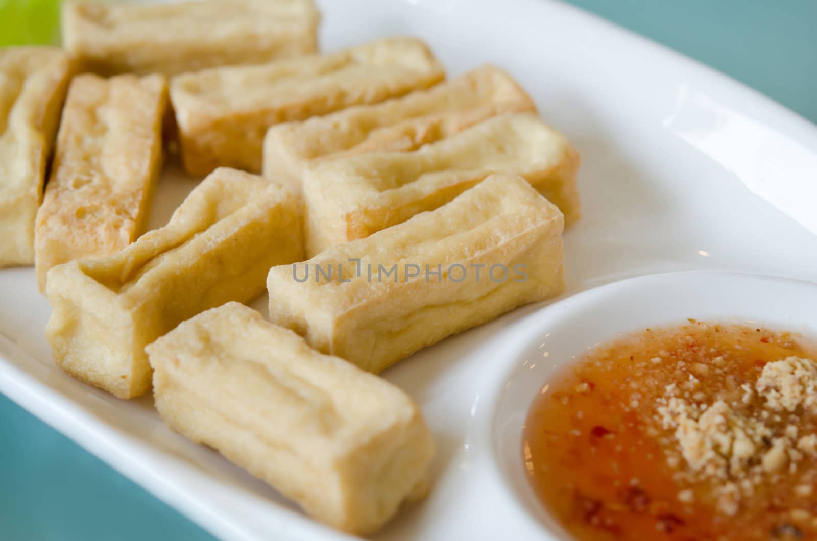 close up deep fried tofu and spicy sauce