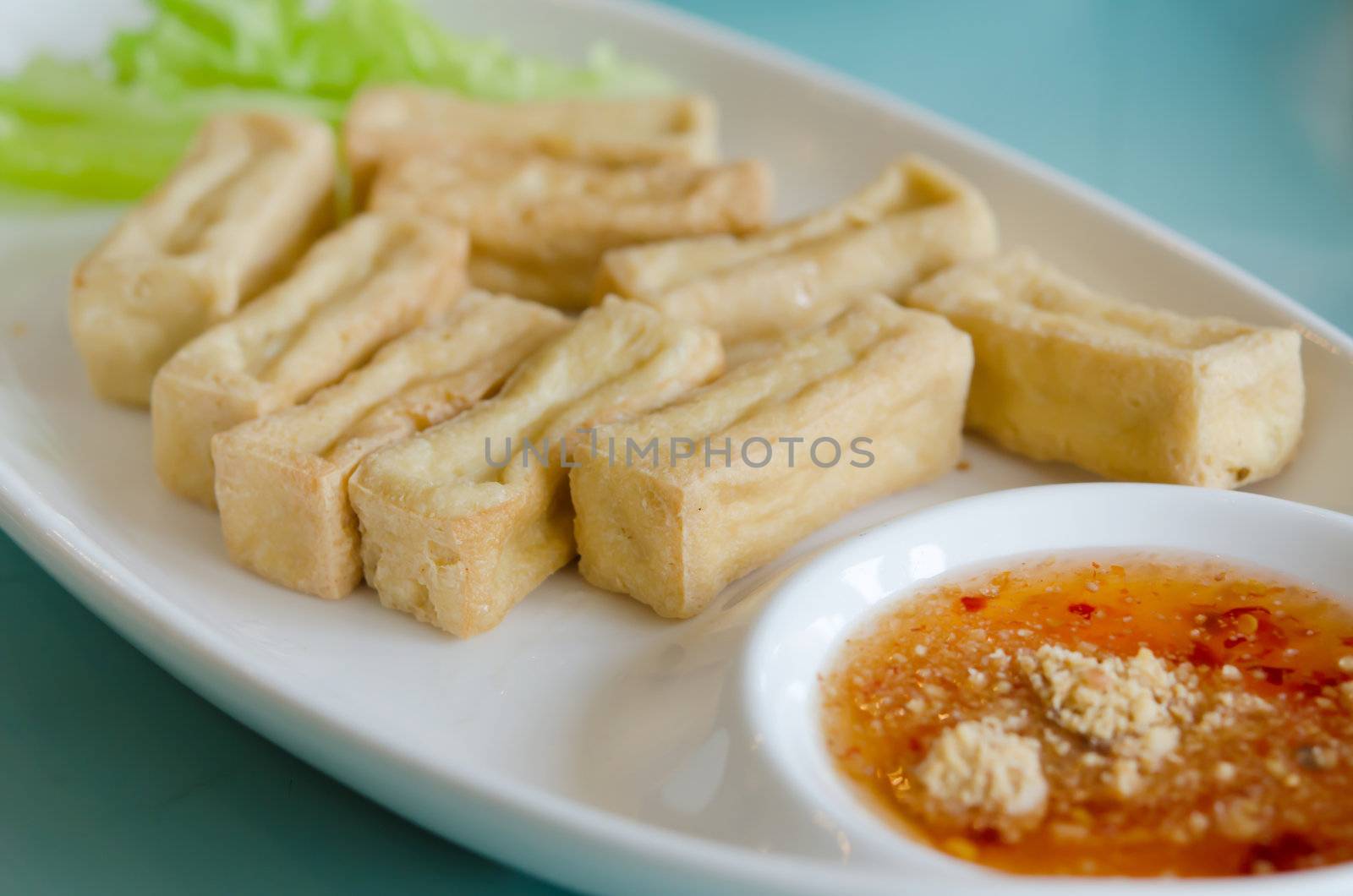 deep fried tofu served with fresh lettuce and  spicy sauce