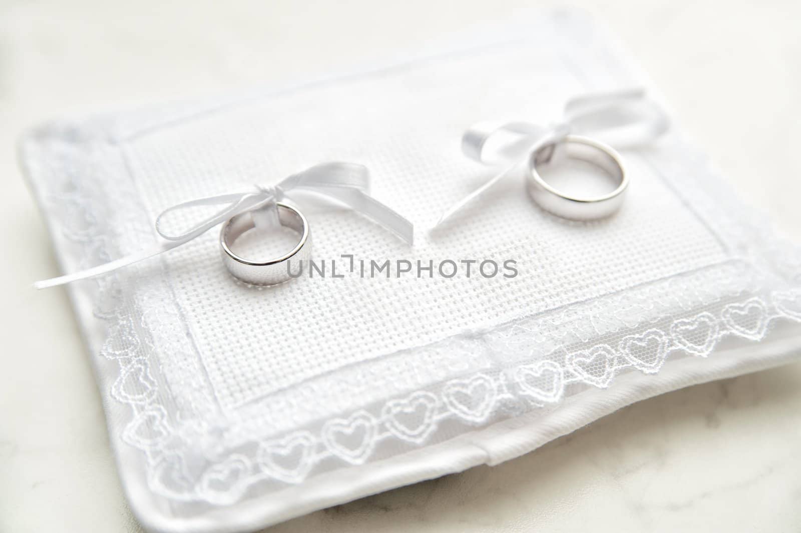 White pad with two wedding rings on it