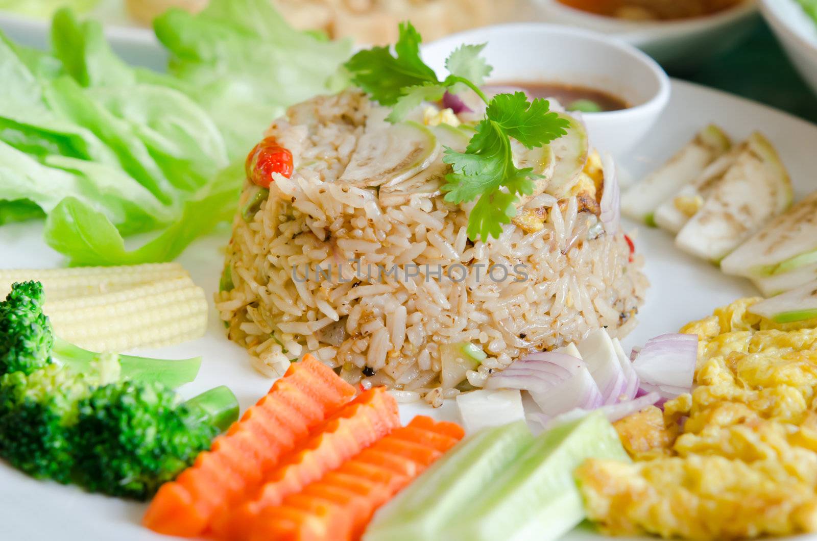 thai cuisine , mixed cooked rice with shrimp paste sauce and fresh vegetable.