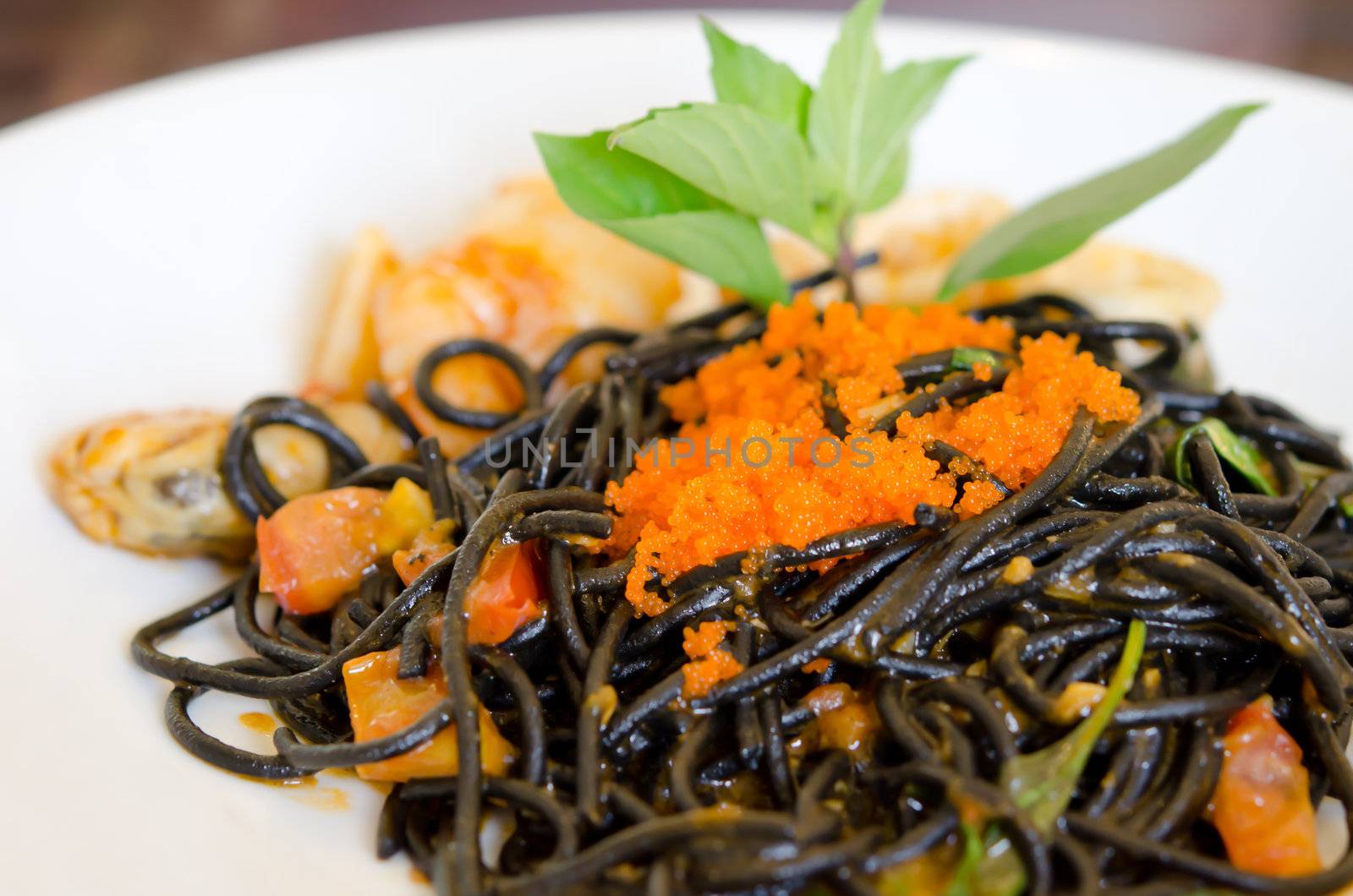 Black spaghetti with seafood  on white dish