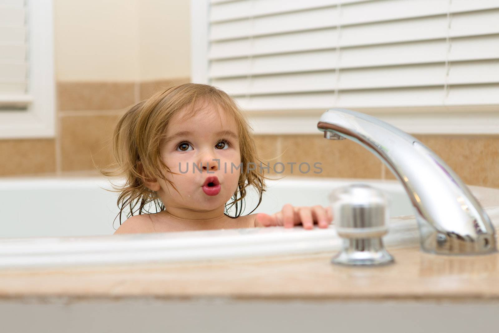 Toddler girl giving expression that needs hot water to take her bath