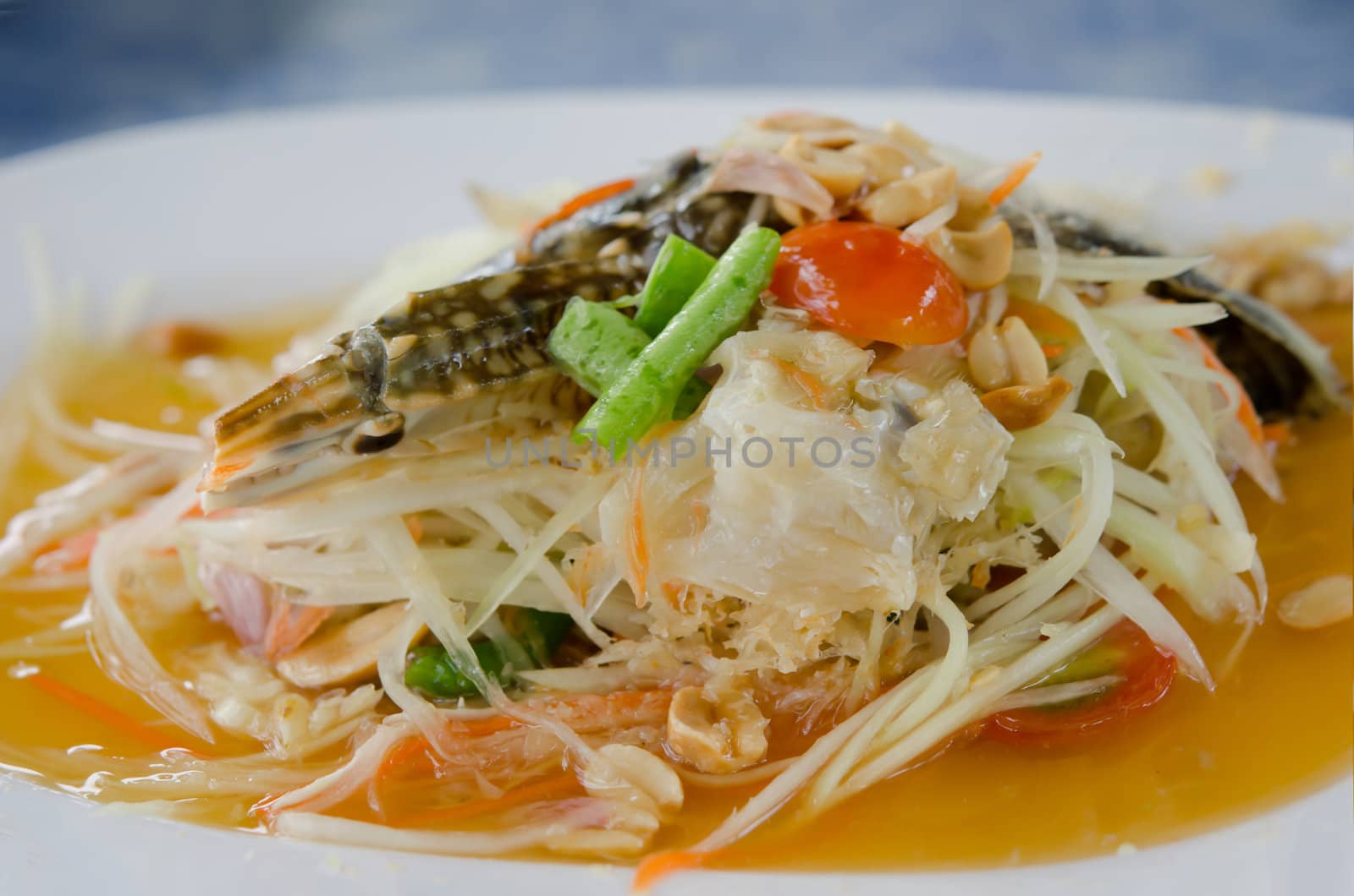 favorite asian food , papaya spicy salad with crabs on white dish