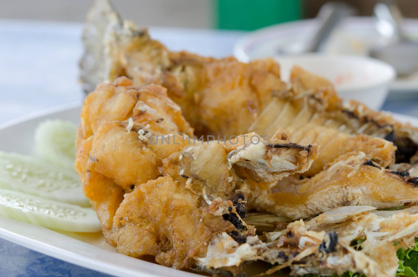 Fish dish - fried fish fillet with vegetables on white plate