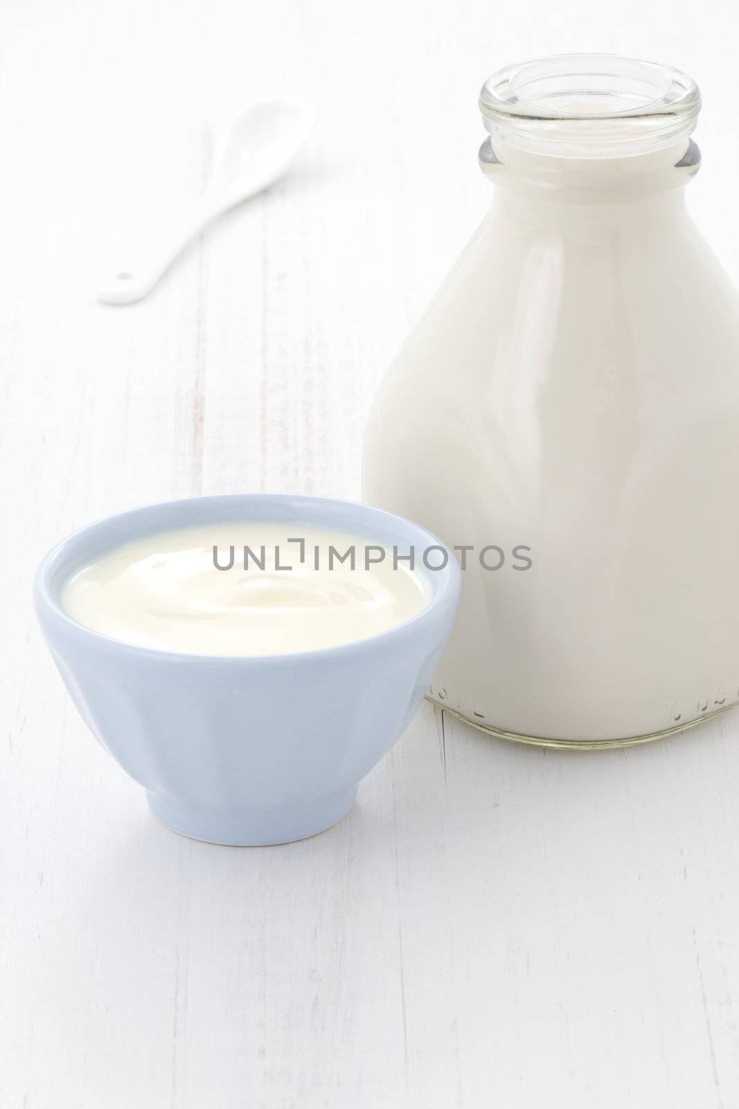 Delicious, nutritious and fresh plain yogurt and milk bottle.