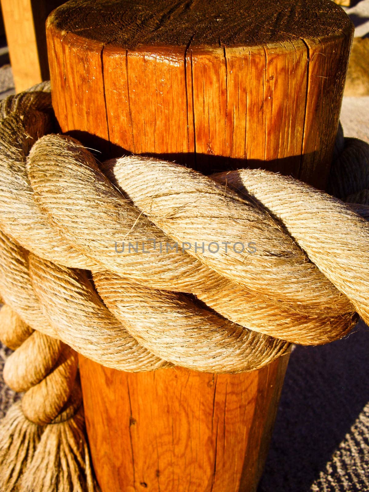 Rope knotted to a wooden post