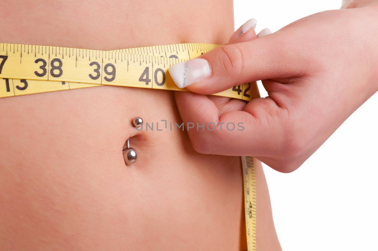 Closeup of a woman measuring her waist with a yellow measuring tape, isolated in white
