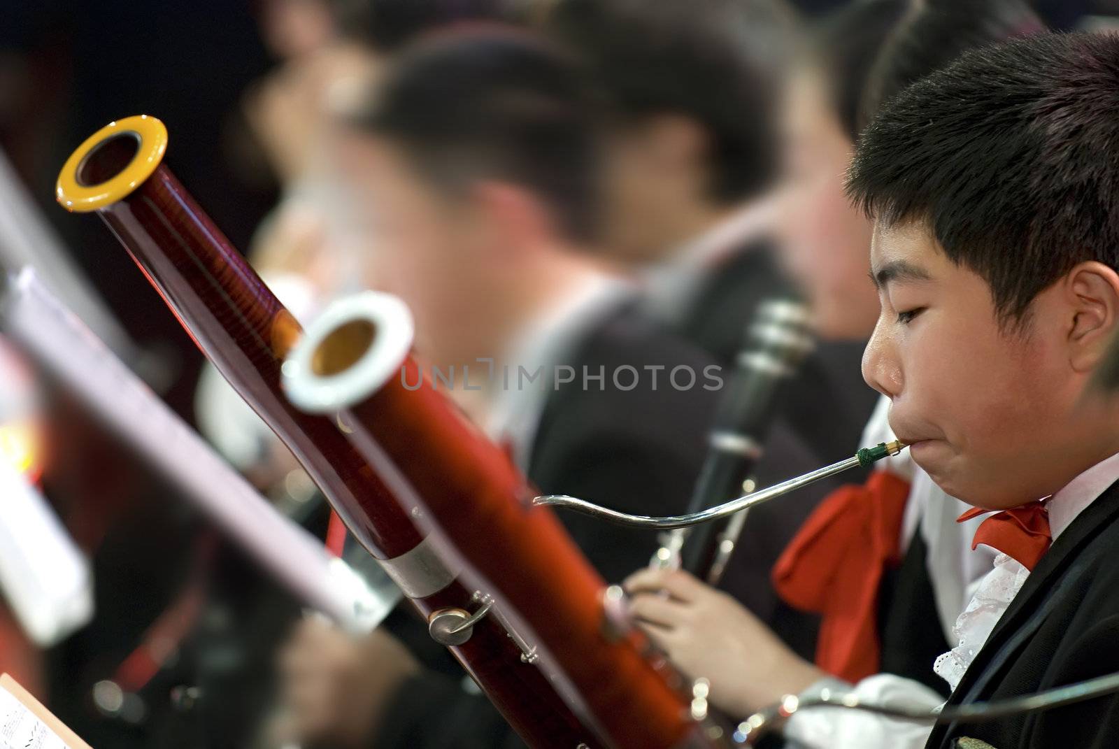 a bassoon boy performing on concert by jackq