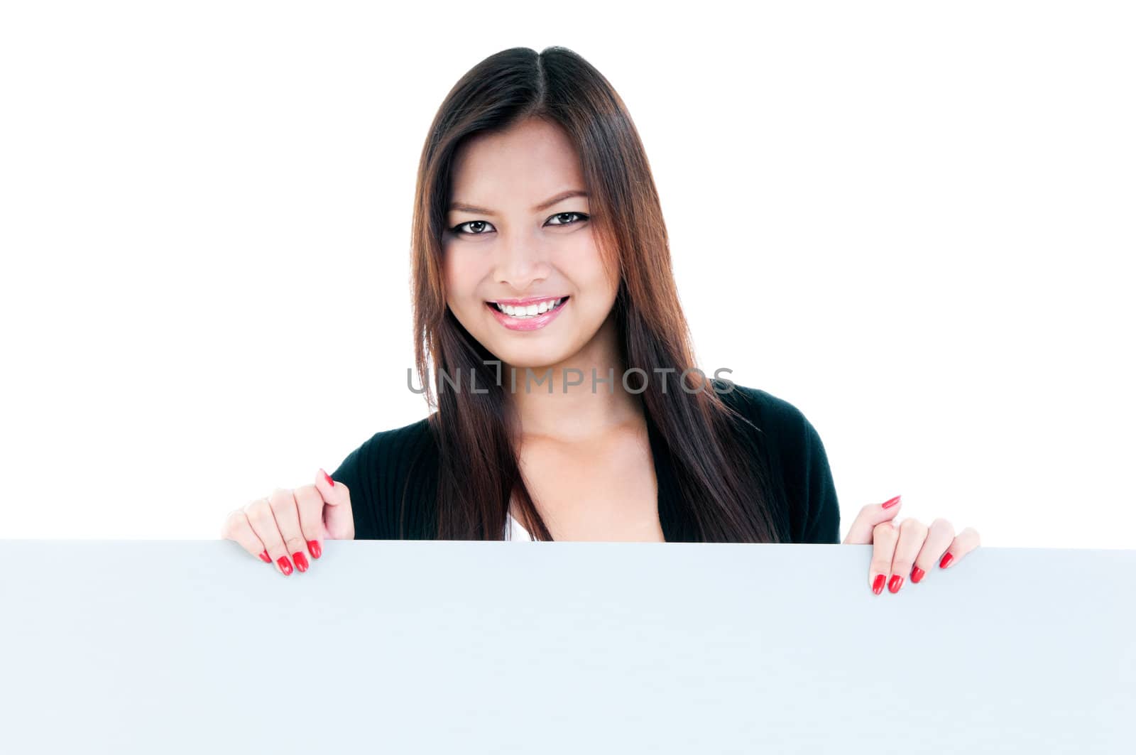 Portrait of an attractive young woman holding blank board against white background.
