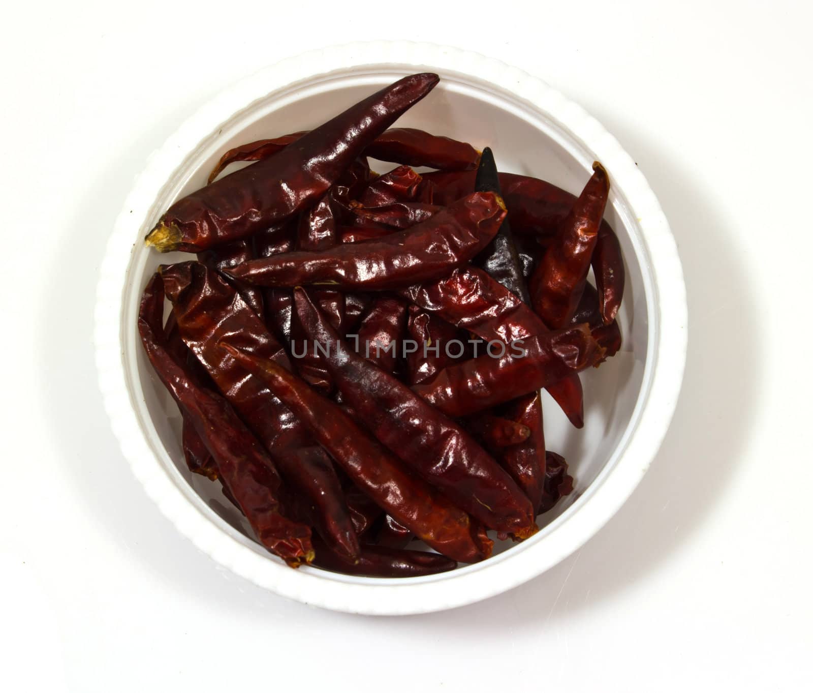 Dry red chili pepper in a  bowl isolated on white background