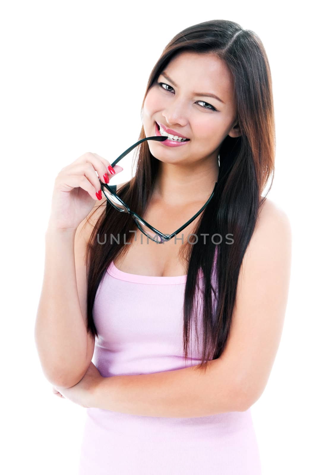 Portrait of pretty young woman with eyeglasses in her mouth against white background.