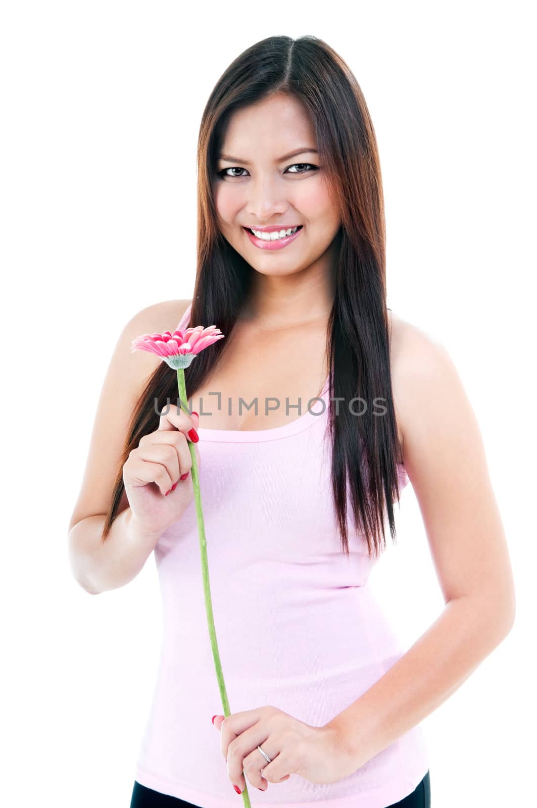 Pretty woman holding pink daisy over white background.