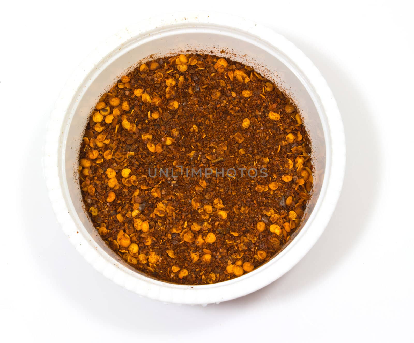 Paprika ground in a white bowl on white background.