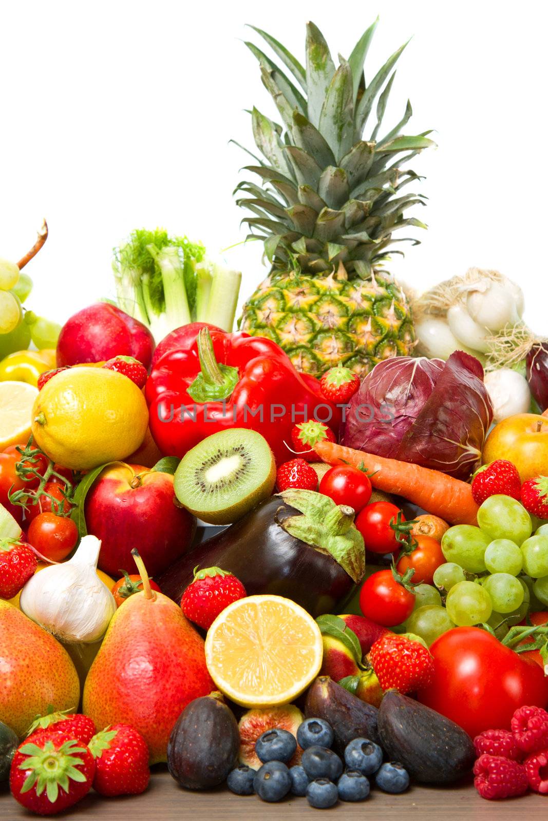 Fruits and vegetables like tomatoes, zucchini, melons, bananas and grapes arranged in a group, natural still life for healthy food 