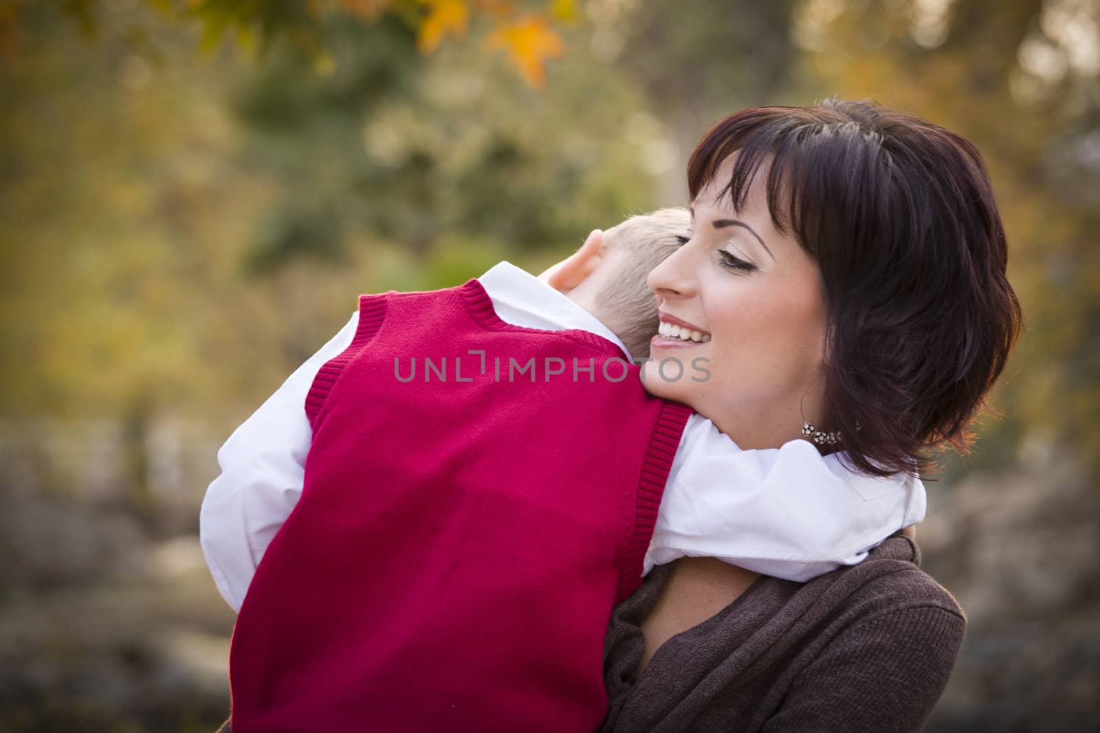 Attractive Mother and Cute Son Portrait Outside at the Park.