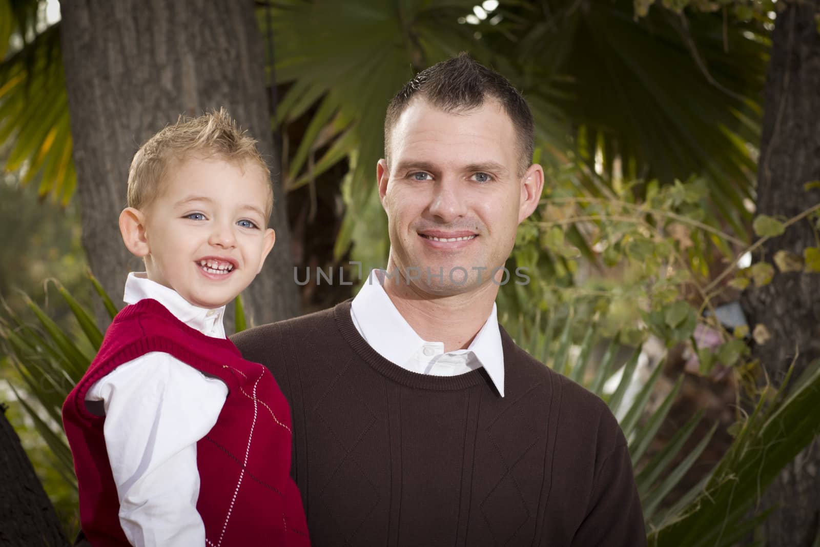 Handsome Father and Son Having Fun in the Park.