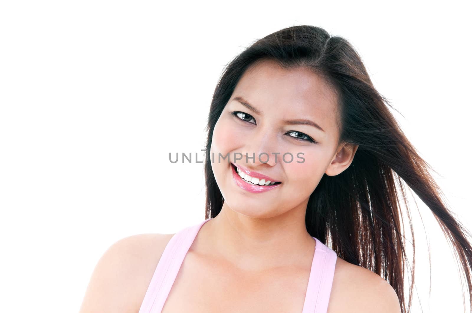 Close-up portrait of an attractive young woman smiling, isolated on white.
