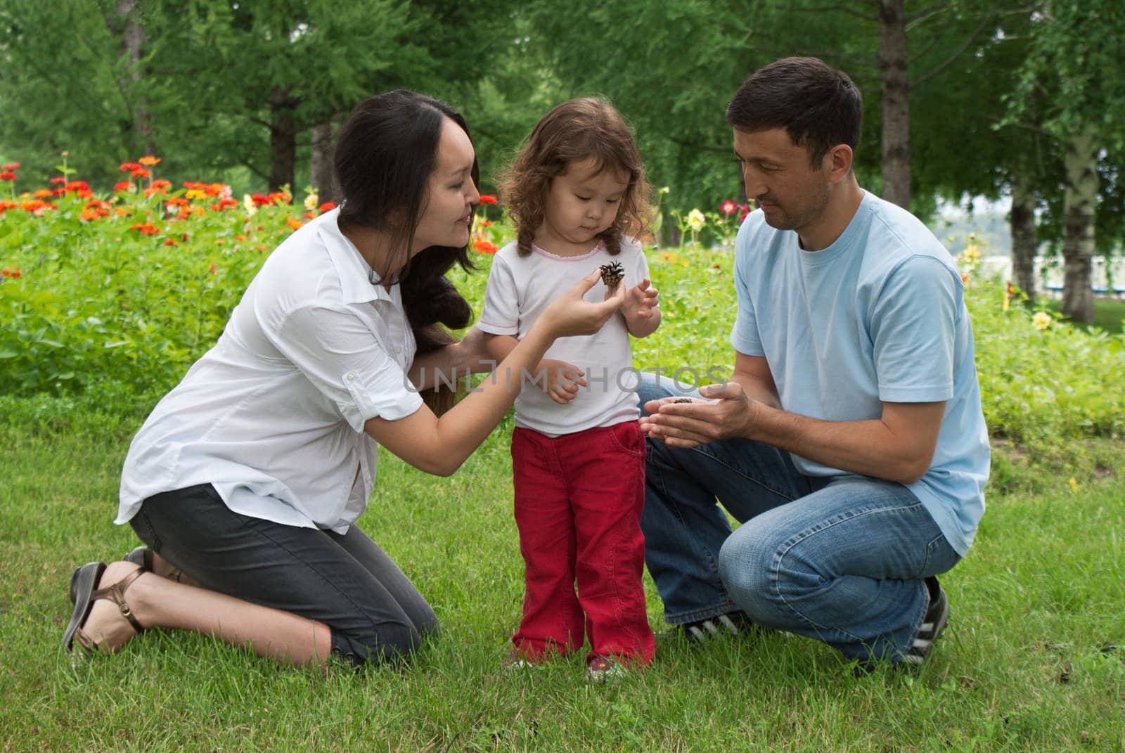 Smiling pregnant woman,  her husband and little daughter