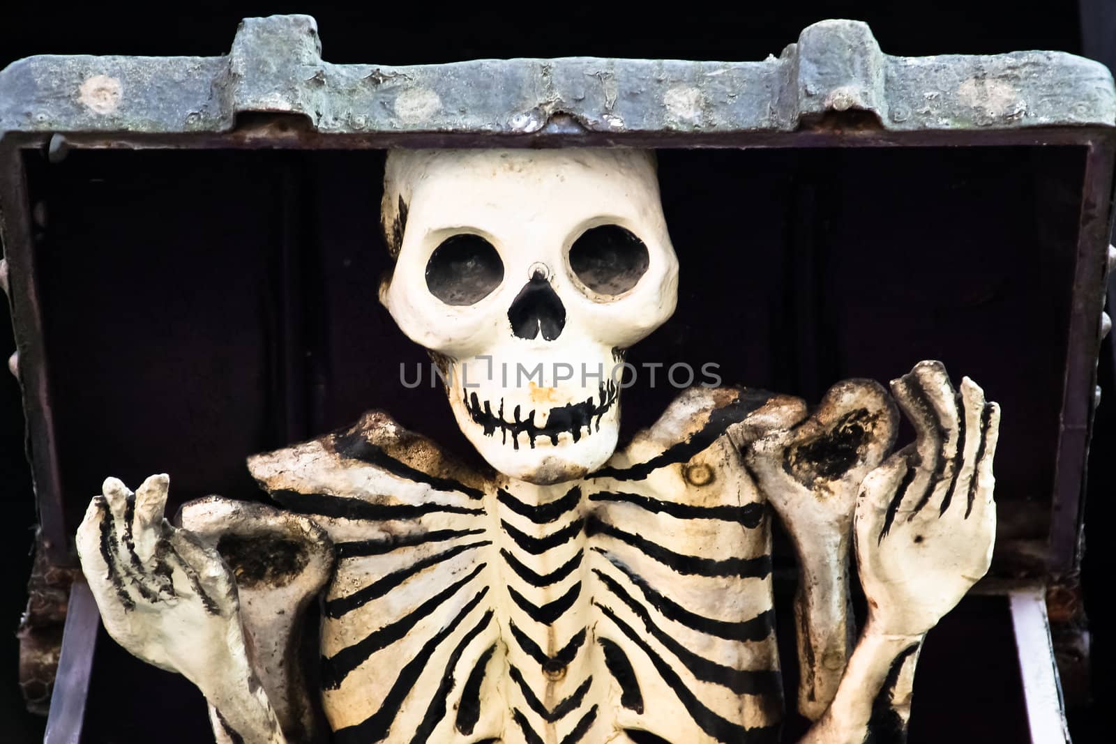 Skeleton out of the box in a haunted house
