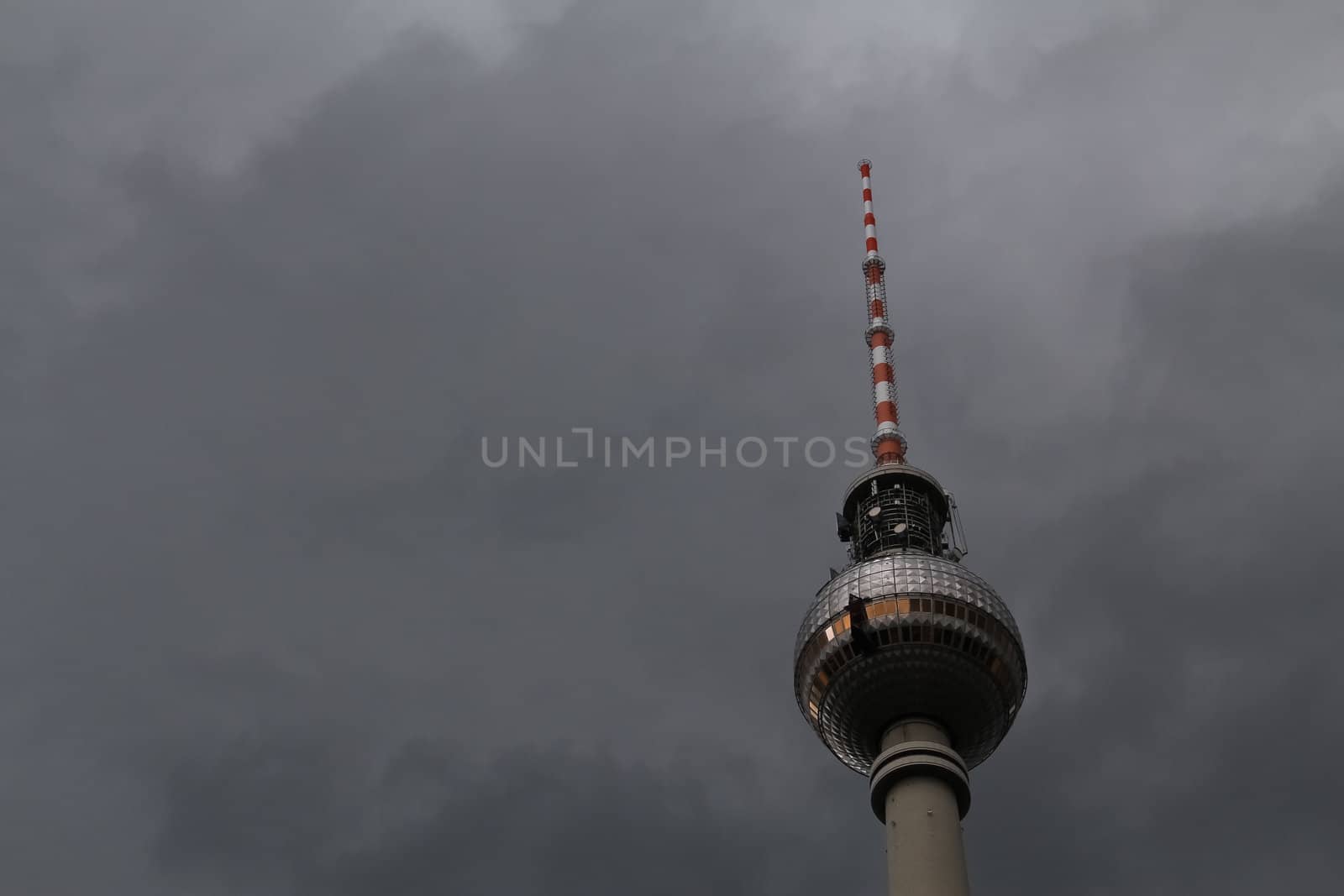 Berlin's broadcasting tower named Alex on dark clouds before a thunderstorm
