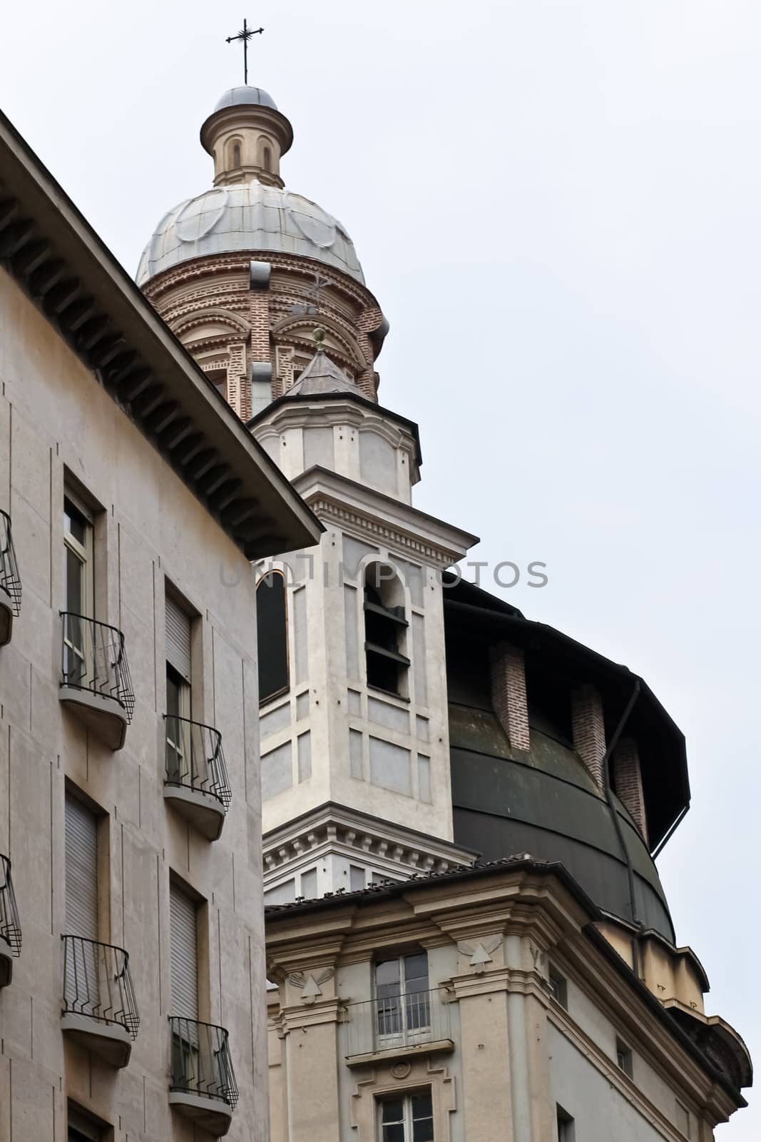 A church tower in the centre of Torino behind a facade