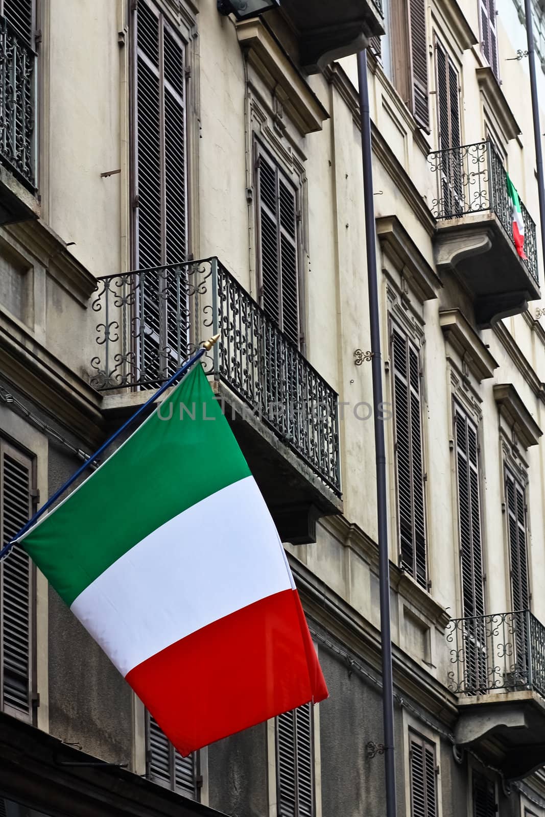 Italian flags on a building celebrating a local anniversary in Torino, Italy